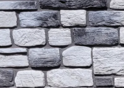 Gray and white rectangular stones arranged in an alternating brick wall pattern.