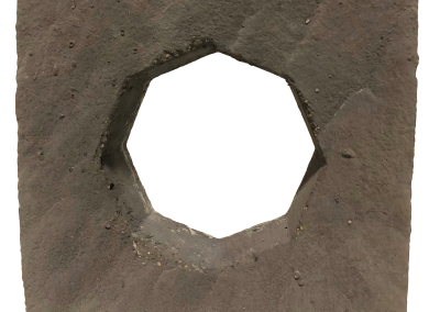 A rough, square stone slab with a hexagonal hole cut out in the center, viewed against a white background.