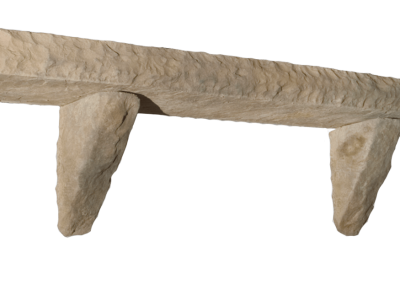 A rustic stone shelf supported by two angled stone brackets, isolated on a white background.