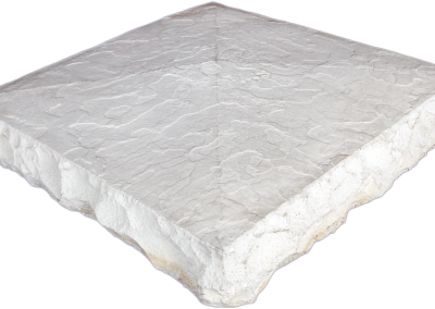 A square, textured, light gray stone tile with rough, uneven edges and a flat top surface.