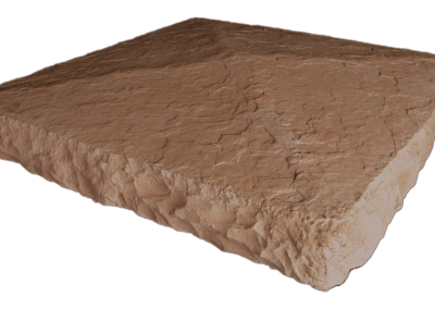 A large, rough-edged, tan stone slab with an uneven surface, viewed from a lower side angle.