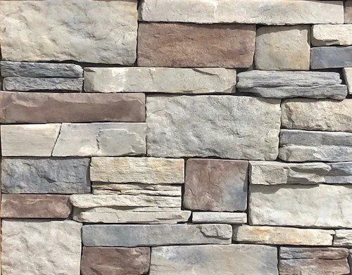 California-Blend-Blue-Ridge A wall made of rectangular, stacked stones in various shades of grey, brown, and beige.