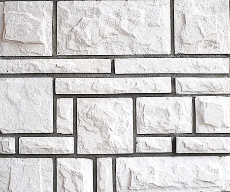 Castlerock-Colonial White textured stone bricks arranged in a geometric, rectangular pattern with gray mortar lines.