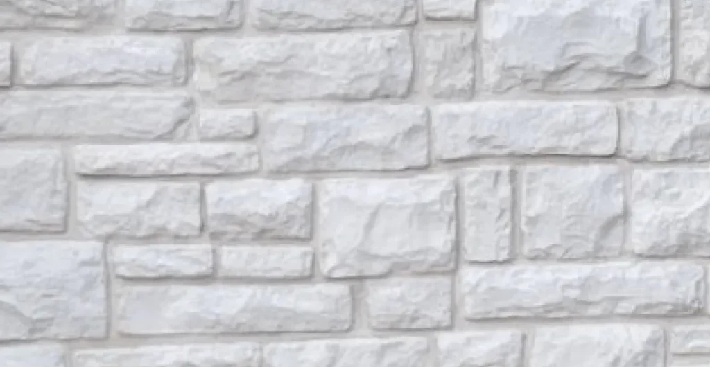 European-Limestone-Colonial-white-grout Light gray stone brick wall with an irregular rectangular pattern and a rough textured surface.