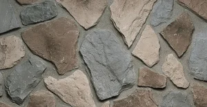 Fieldstone-Buckskin Irregularly shaped gray and brown stones arranged in a mortar wall pattern.