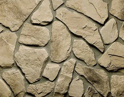 Fieldstone-Northern Irregularly shaped beige stones arranged closely together, forming a stone wall with visible grout lines.