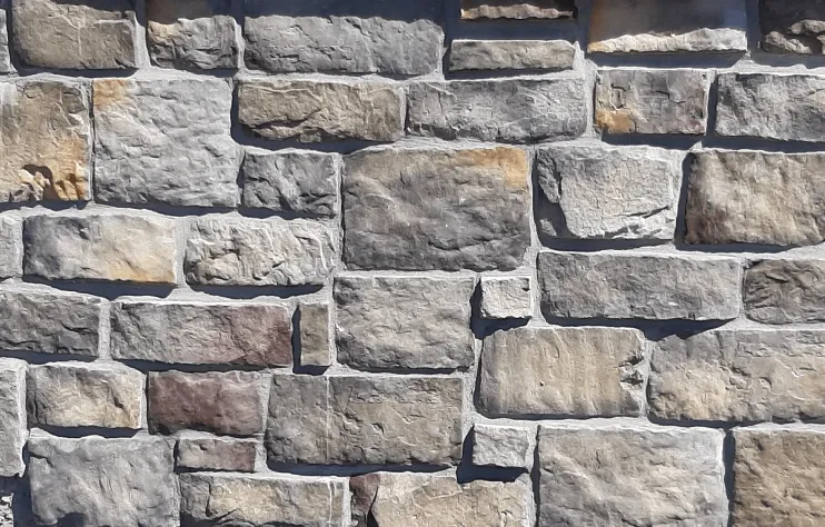 Hackett-Bucks-County-Caribou A close-up of a stone wall with variously sized rectangular gray and tan stones.
