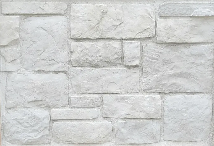 Hackett-Colonial Gray and white stone wall with rectangular and square blocks arranged in a staggered pattern.