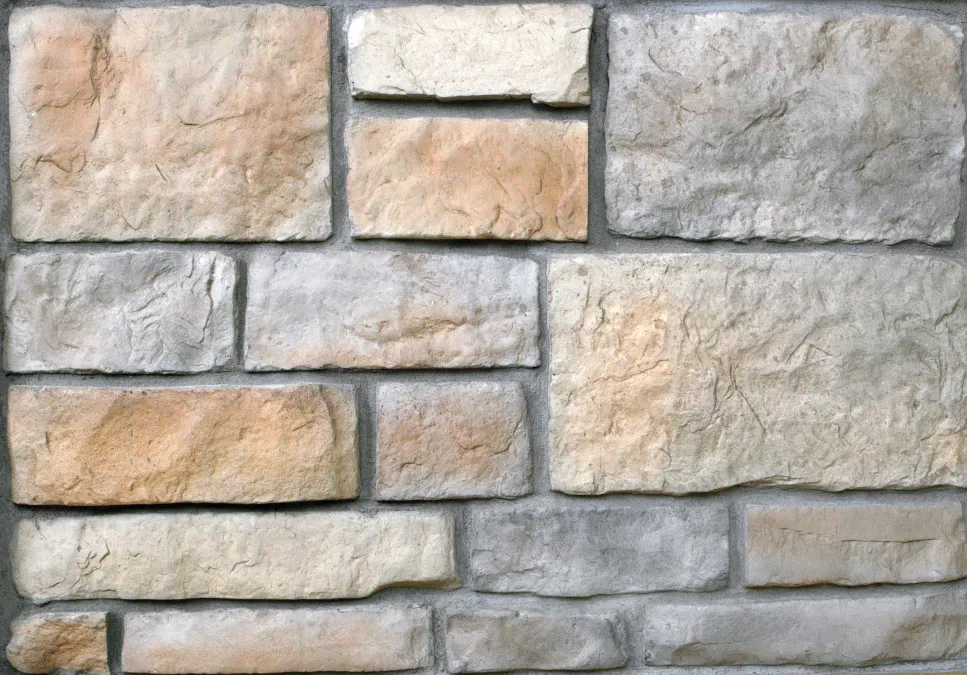 Hackett-Ohio Rectangular beige and gray stone bricks arranged in a staggered horizontal pattern on a wall.