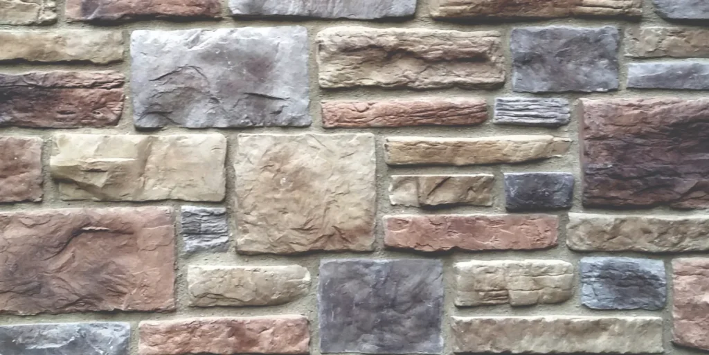 Minnesota-Limestone-Buckskin A close-up of a wall made of variously sized and colored rectangular stones.