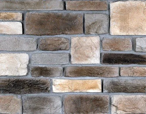 Minnesota-Limestone-Sienna A close-up of a stone brick wall with various shades of brown, beige, and gray rectangular stones.