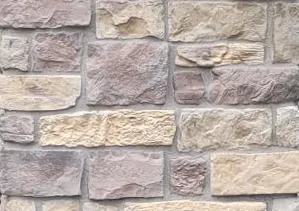 Tan and gray rectangular stone bricks arranged in a horizontal pattern on a wall.