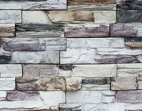 Stacked stone wall with various shades of gray, white, and beige rectangular stones.