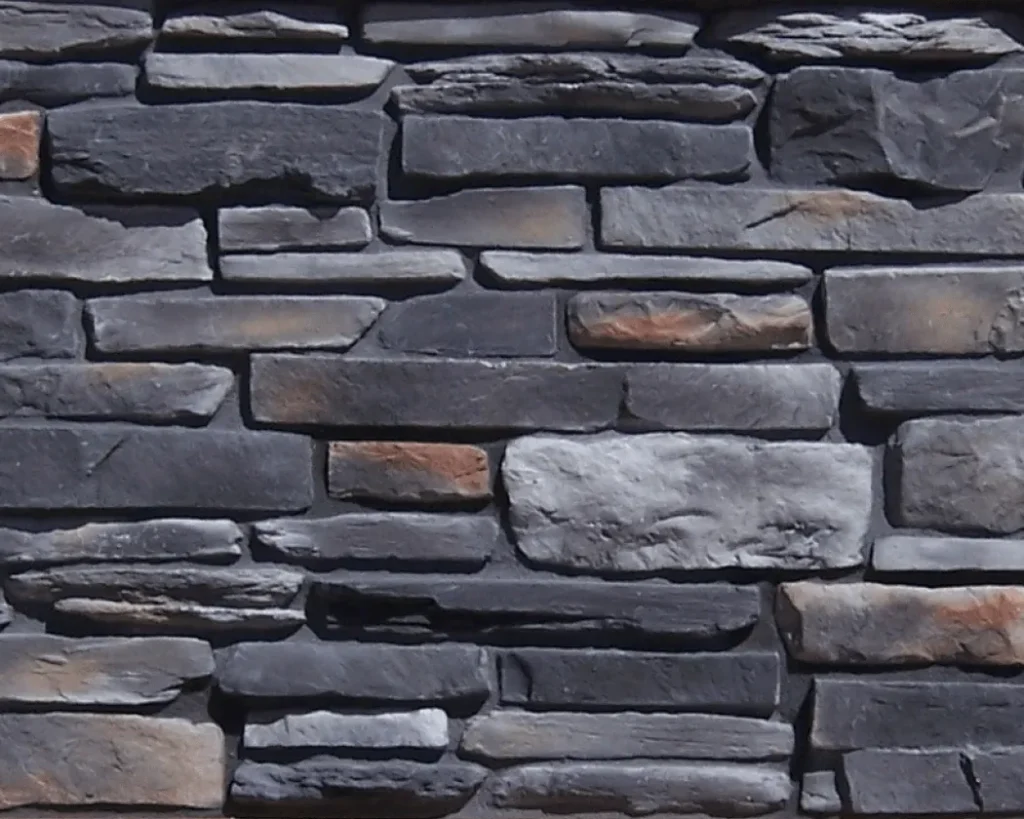 Mountain-Ledgestone-Onyx-1 A close-up of a stone wall with gray, rectangular stones stacked in an irregular pattern.