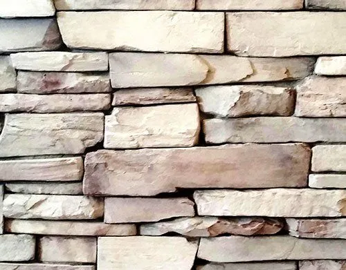 Prairie-Ledgestone-Glacier Stacked stone wall with uneven, rectangular beige stones arranged in a horizontal pattern.