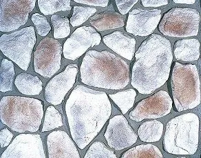 Irregularly shaped, light-colored stones set in gray mortar, forming a stone wall pattern.